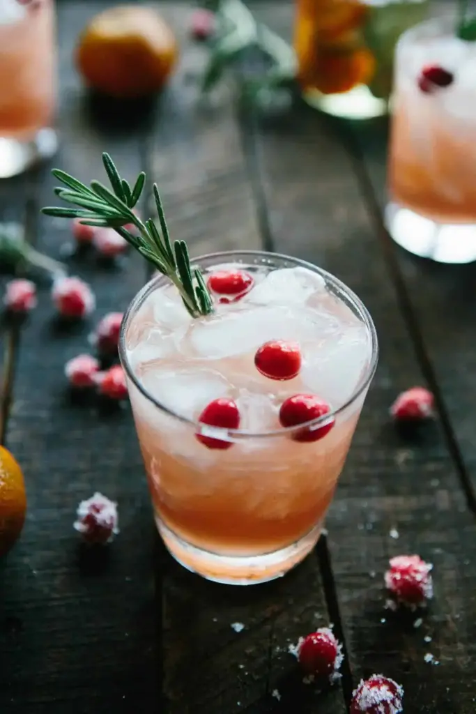 Christmas Cocktail garnished with cranberries and rosemary
